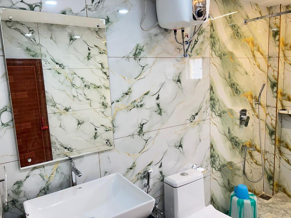 Cottage bathroom basin, mirror and shower at Chamtaburu Eco Village, Ajodhya Hills