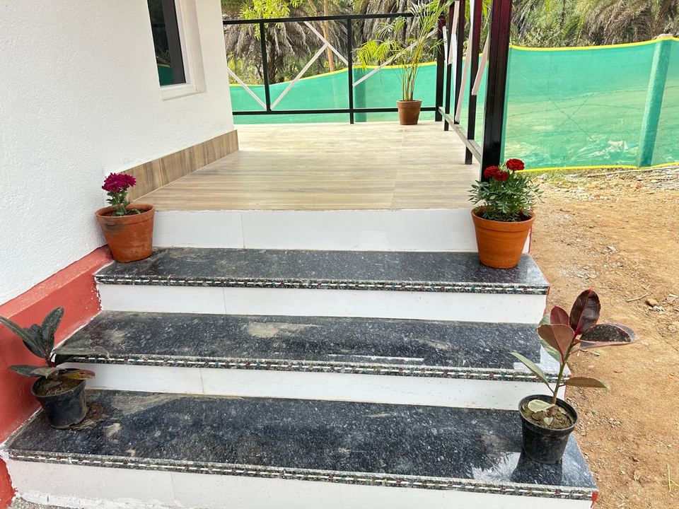 Granite entrance steps with potted plants at a Chamtaburu Eco Village cottage, Ajodhya Hills